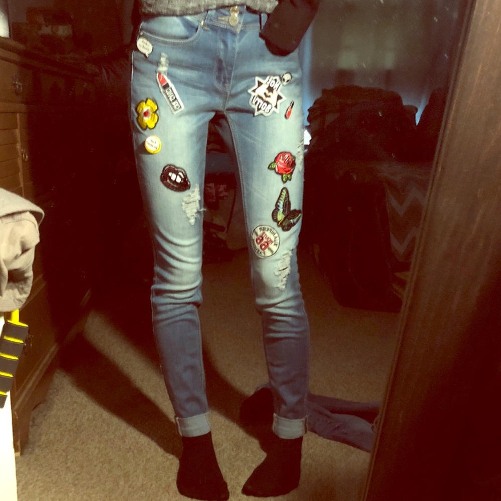 Patched and pinned jeans